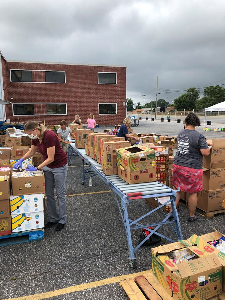 Volunteers prepare food to be picked up at food bank 