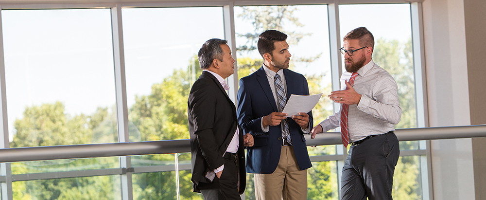 Group of three employees in an office