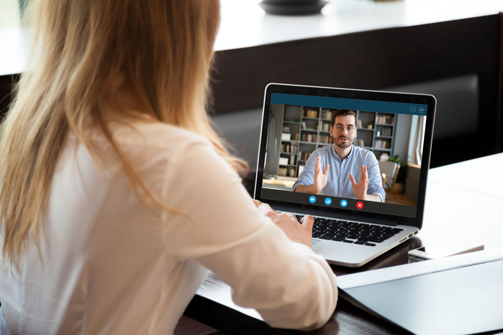 woman talking with therapist on computer