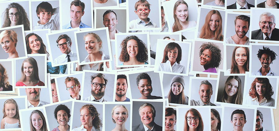 Snapshots of people of different genders and ethnicities are spread out over a surface